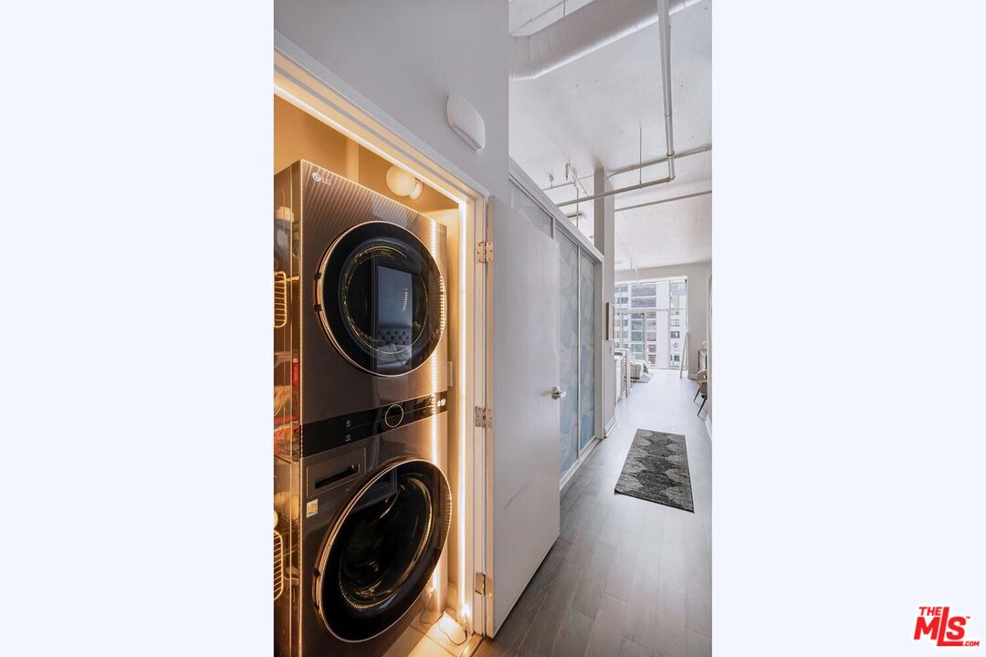 645 West 9th Street, Unit 740 Los Angeles, CA 90015 - Photo 31 of 63 a view of a hallway with washer and dryer