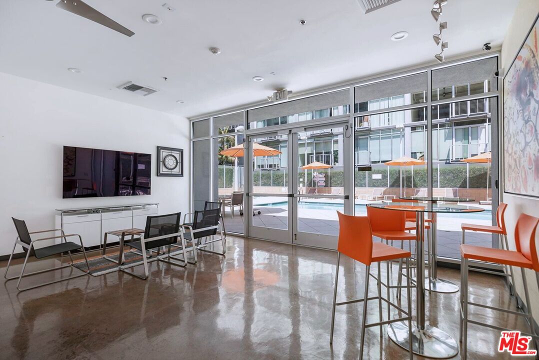 645 West 9th Street, Unit 740 Los Angeles, CA 90015 - Photo 38 of 63 a living room with furniture and a flat screen tv