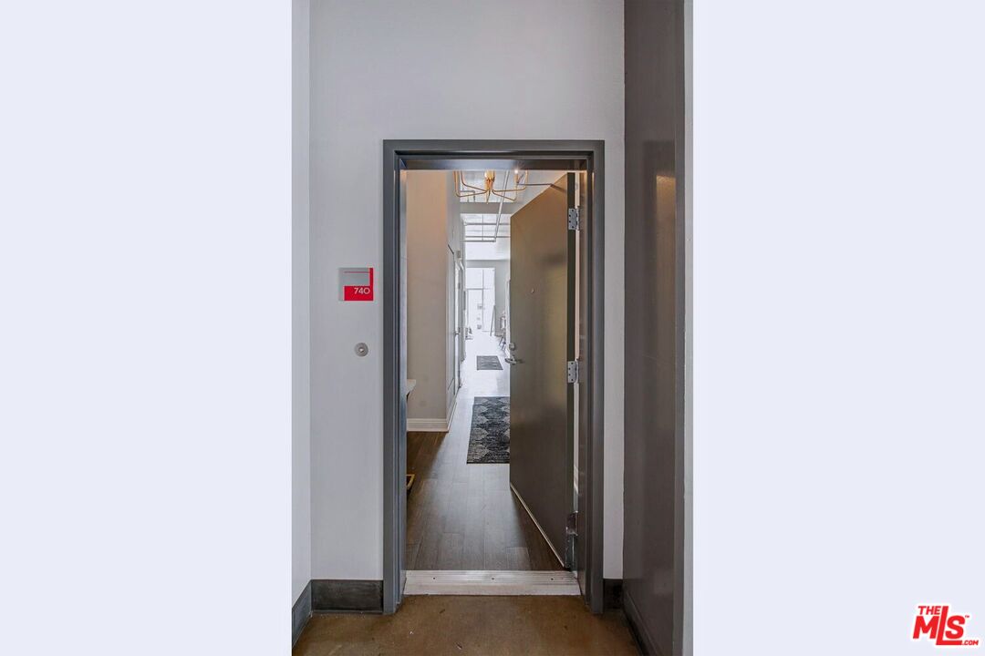 645 West 9th Street, Unit 740 Los Angeles, CA 90015 - Photo 6 of 63 a view of a hallway with wooden floor
