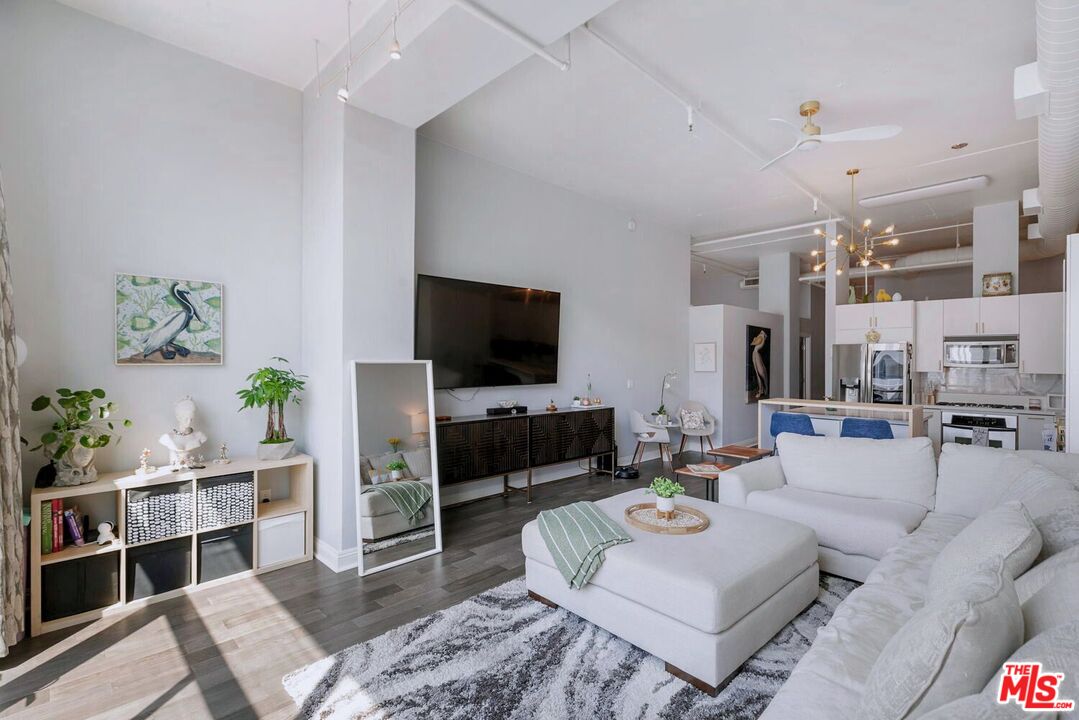 645 West 9th Street, Unit 740 Los Angeles, CA 90015 - Photo 9 of 63 a living room with furniture and a flat screen tv