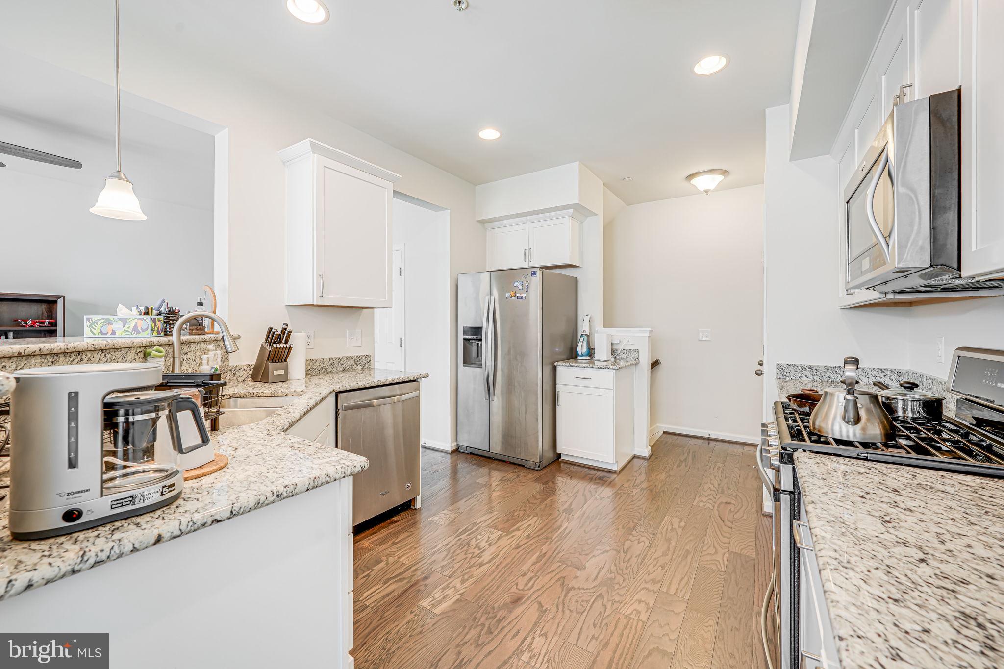 43373 Town Gate Square Chantilly, VA 20152 - Photo 11 of 30 a kitchen with granite countertop a refrigerator stove and sink