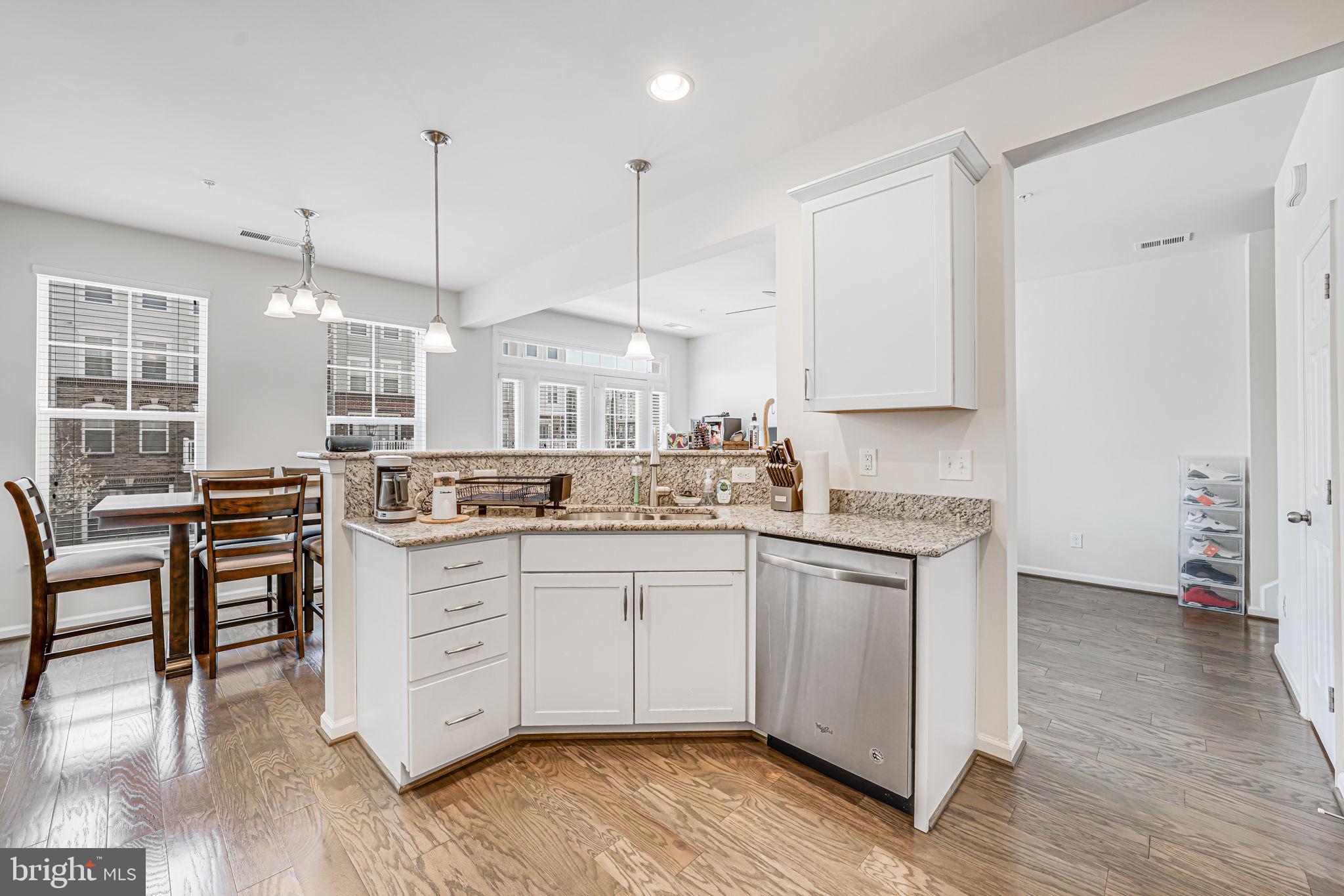 43373 Town Gate Square Chantilly, VA 20152 - Photo 13 of 30 a kitchen with stainless steel appliances granite countertop a sink a stove and a wooden floors