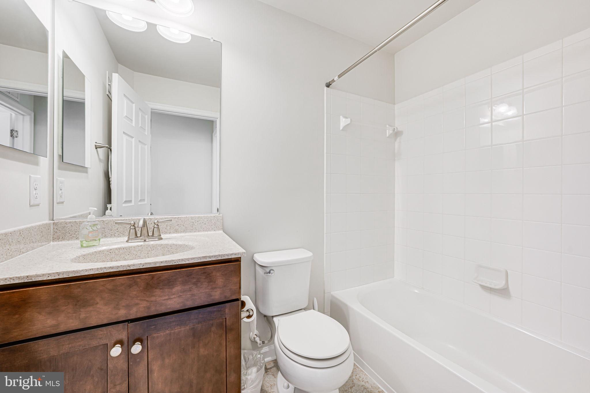 43373 Town Gate Square Chantilly, VA 20152 - Photo 17 of 30 a bathroom with a sink a toilet a mirror and shower