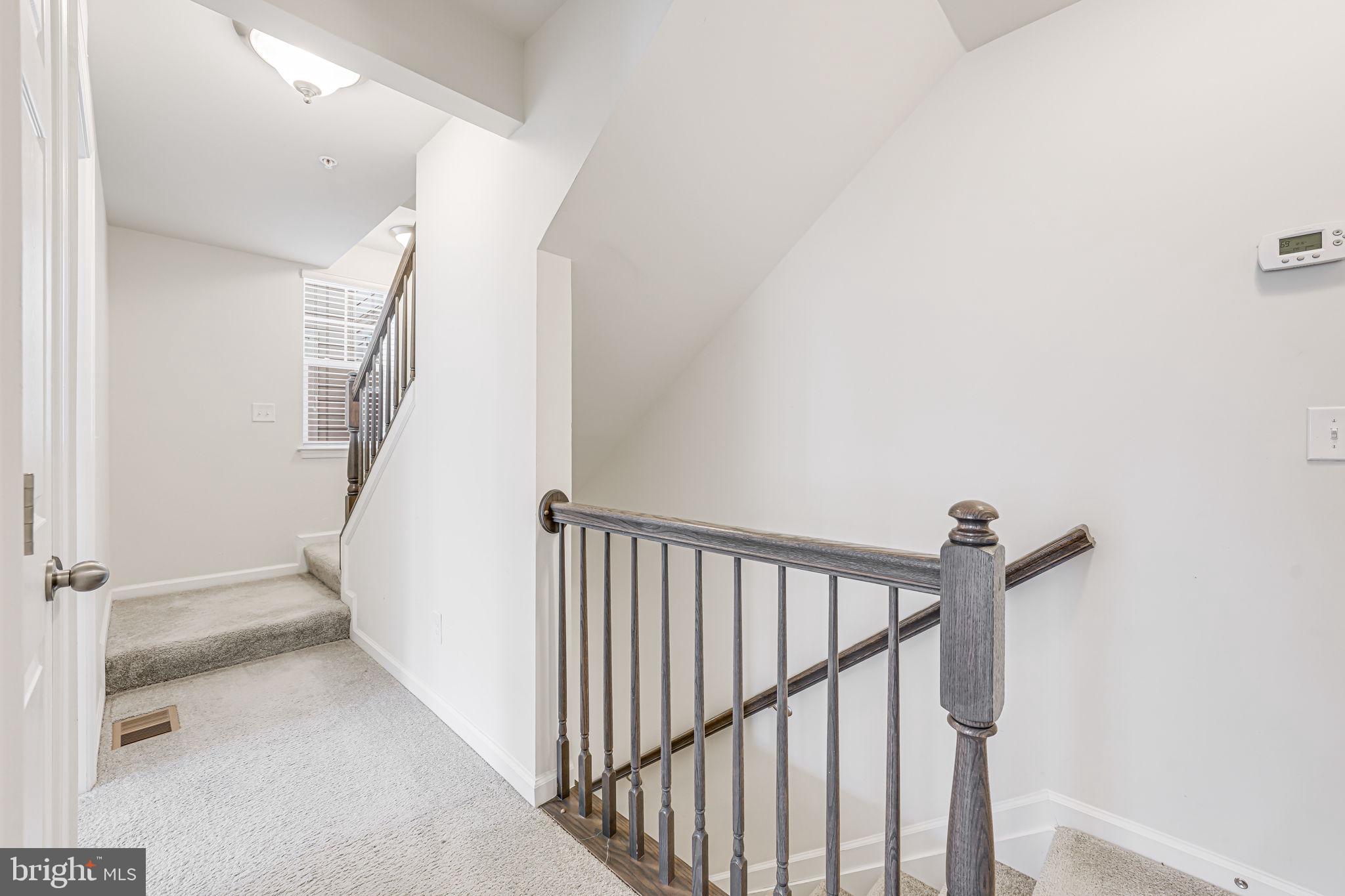 43373 Town Gate Square Chantilly, VA 20152 - Photo 18 of 30 a view of staircase with wooden floor and white walls