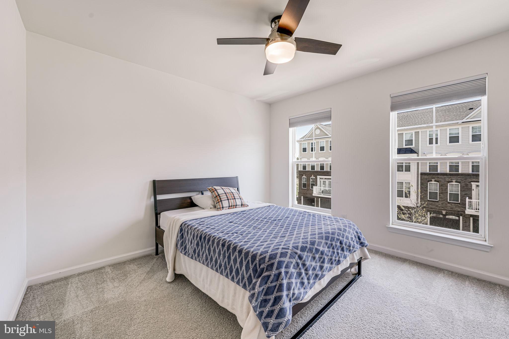 43373 Town Gate Square Chantilly, VA 20152 - Photo 19 of 30 a bedroom with a large bed and a large window
