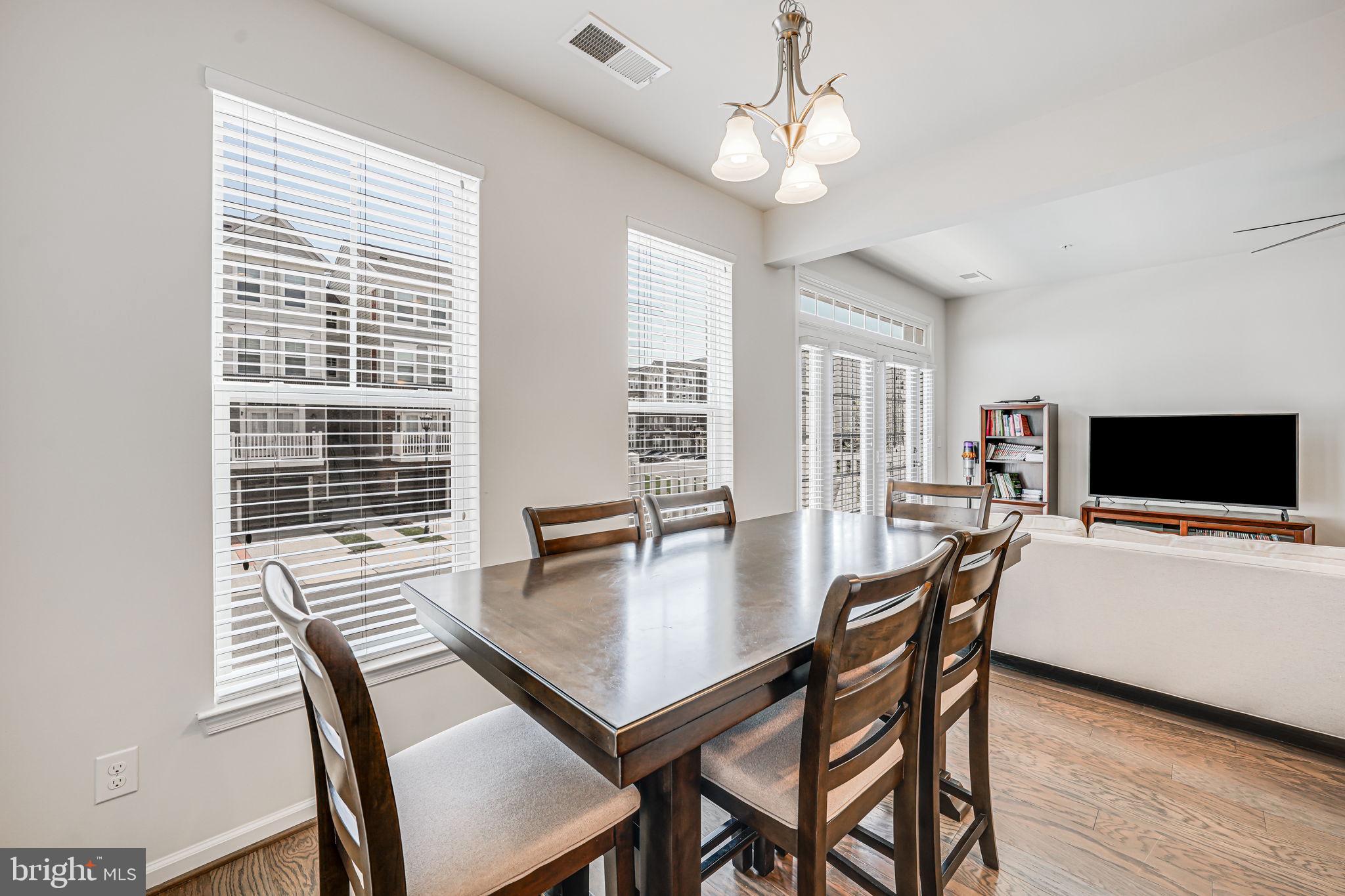43373 Town Gate Square Chantilly, VA 20152 - Photo 10 of 30 a view of a dining room with furniture window and wooden floor
