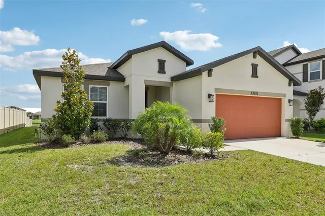 a front view of house with yard and green space