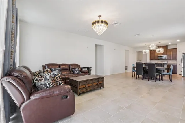 a living room with furniture and a dining table