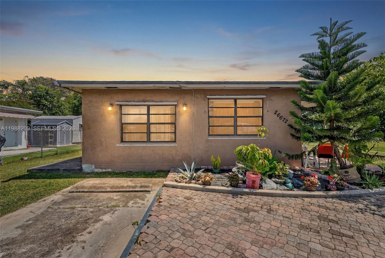 a front view of a house with a yard and a garage