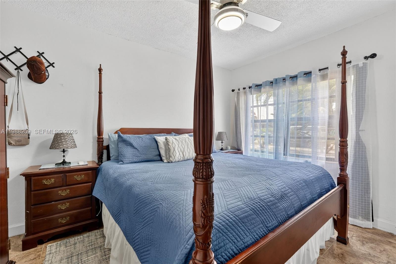 26672 Southwest 137th Court Homestead, FL 33032 - Photo 11 of 34 a bedroom with a bed and window