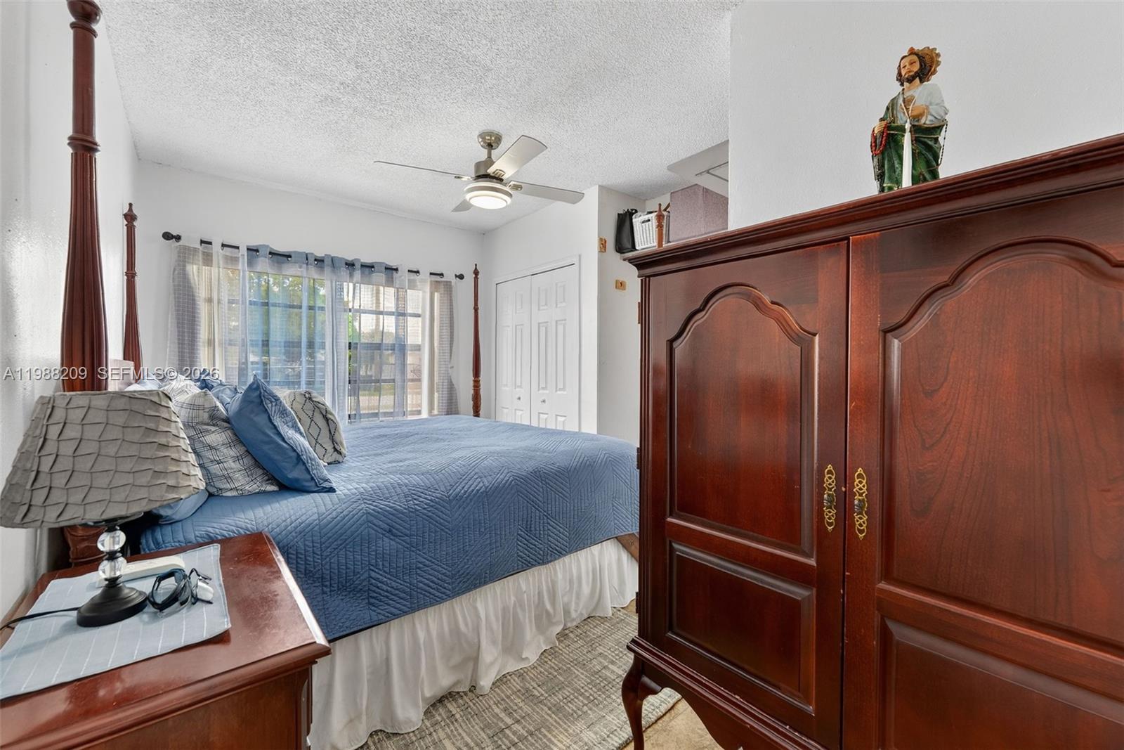 26672 Southwest 137th Court Homestead, FL 33032 - Photo 13 of 34 a bedroom with a bed and dresser with wooden floor