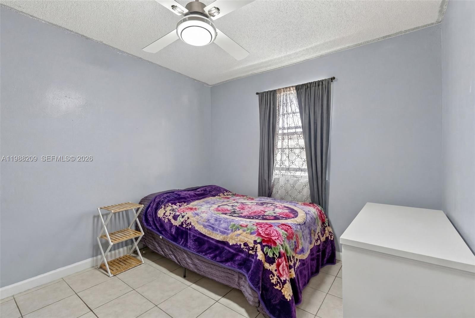 26672 Southwest 137th Court Homestead, FL 33032 - Photo 15 of 34 a bedroom with a bed and a window