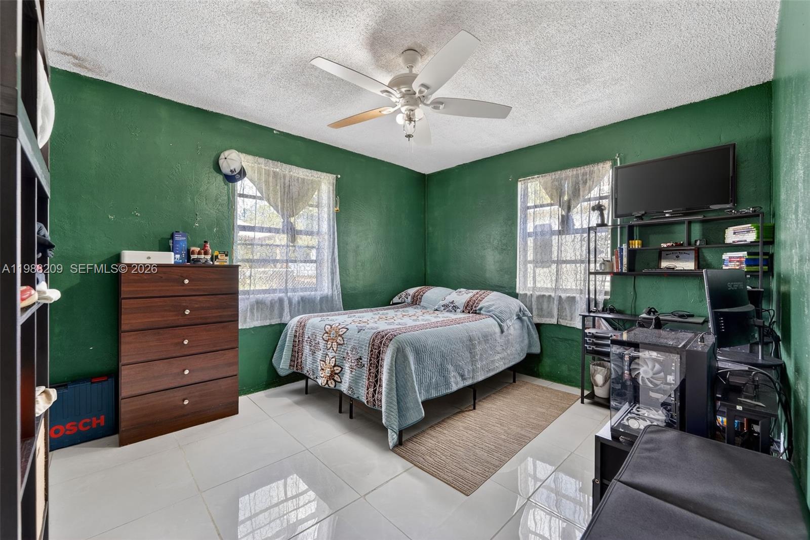 26672 Southwest 137th Court Homestead, FL 33032 - Photo 17 of 34 a bedroom with a bed window and a ceiling fan