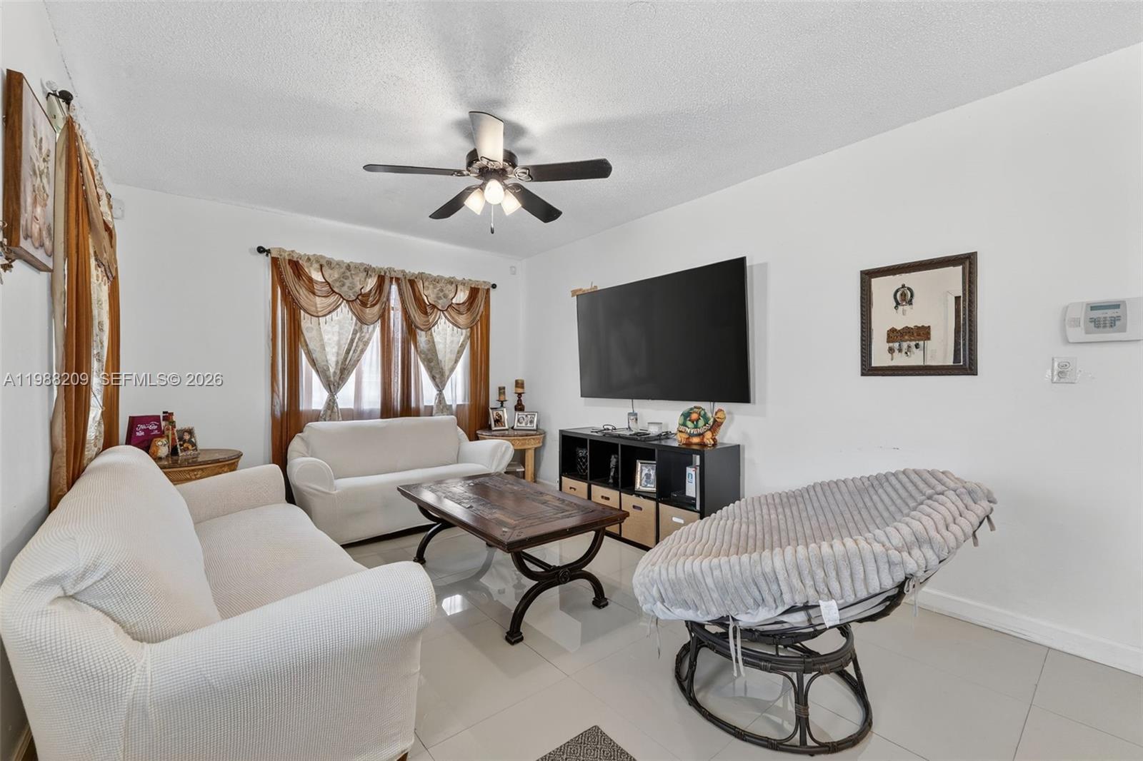 26672 Southwest 137th Court Homestead, FL 33032 - Photo 4 of 34 a living room with furniture and a flat screen tv