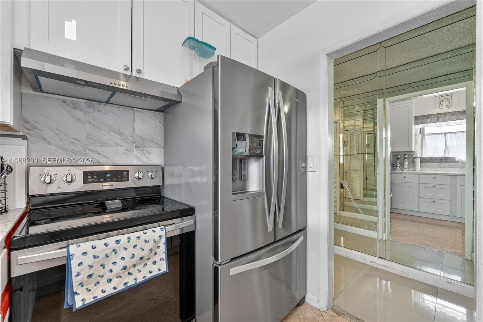 26672 Southwest 137th Court Homestead, FL 33032 - Photo 9 of 34 a kitchen with stainless steel appliances granite countertop a refrigerator and a stove