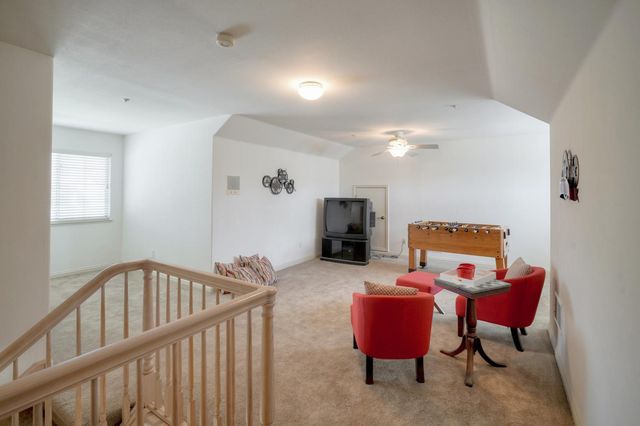 a view of a hallway with couch and a workspace