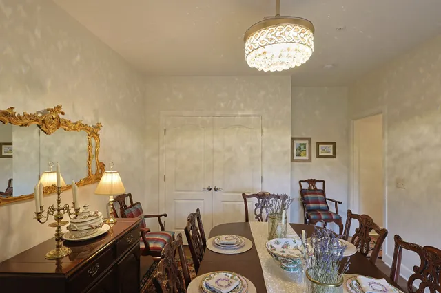 a view of a dining room with furniture wooden floor and a chandelier
