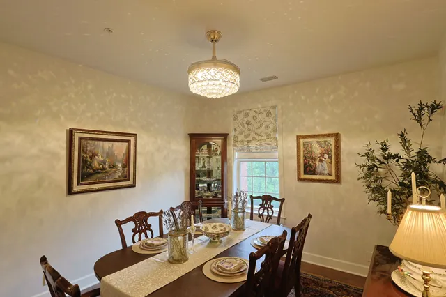 a bathroom with a granite countertop sink toilet and mirror