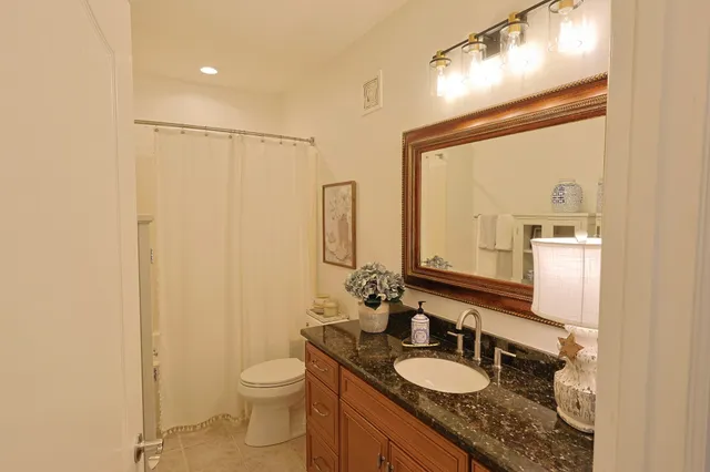 a living room with furniture and a mirror