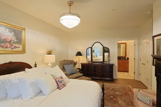 a living room with furniture a rug and a painting on the wall