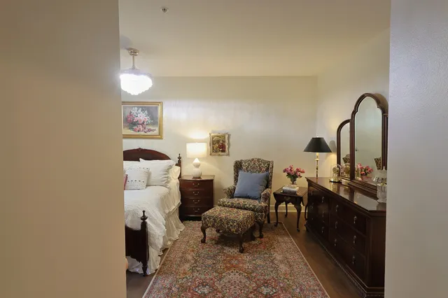 a bedroom with furniture and a window