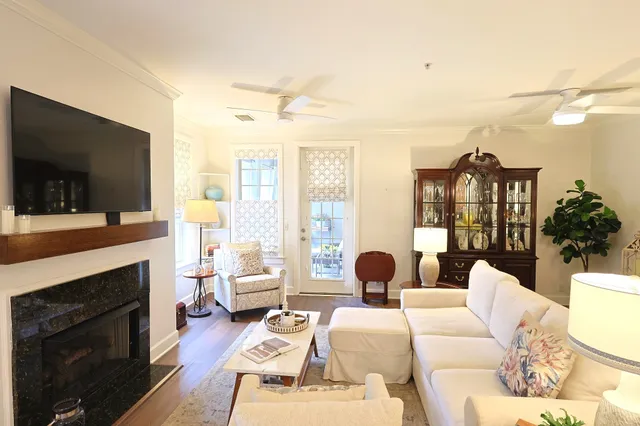 a living room with furniture fireplace and flat screen tv