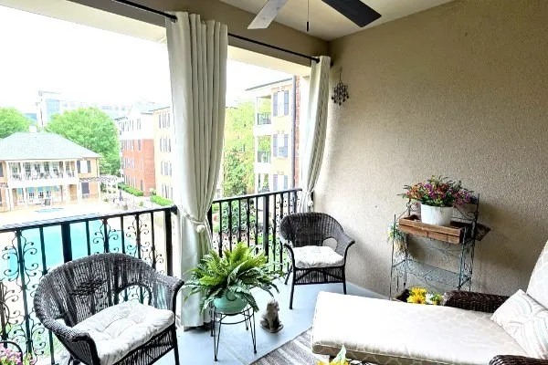 a view of a brick house with many windows and a yard