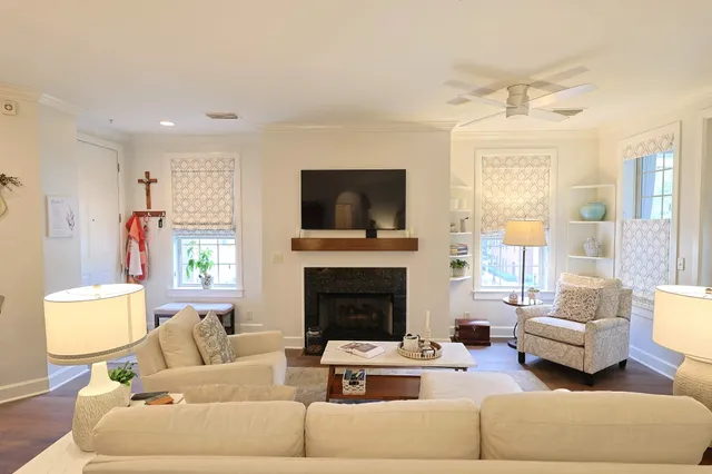 a living room with furniture a fireplace and a flat screen tv