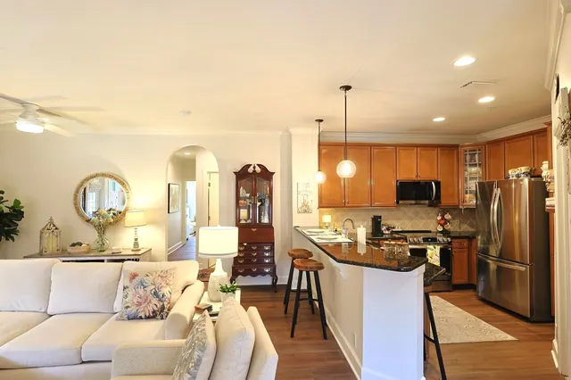 a living room with stainless steel appliances kitchen island granite countertop furniture and a kitchen view