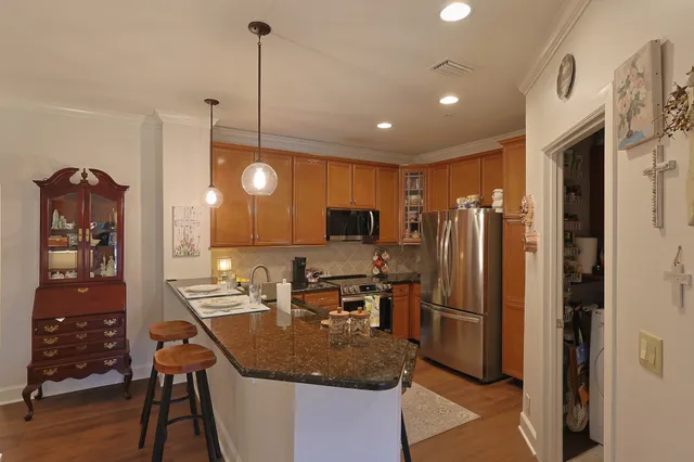a kitchen with stainless steel appliances granite countertop sink refrigerator and microwave