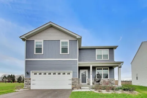 a view of a house with a yard and plants