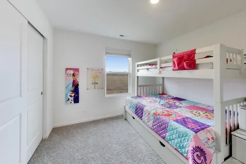 a view of walk in closet with clothes