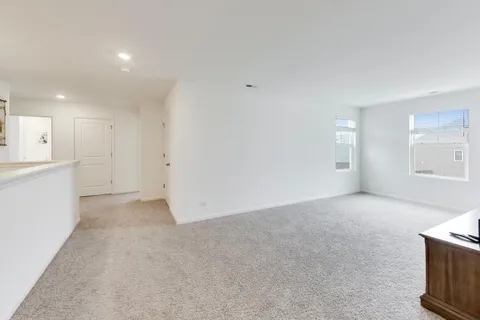 a spacious bedroom with a bed and a dresser