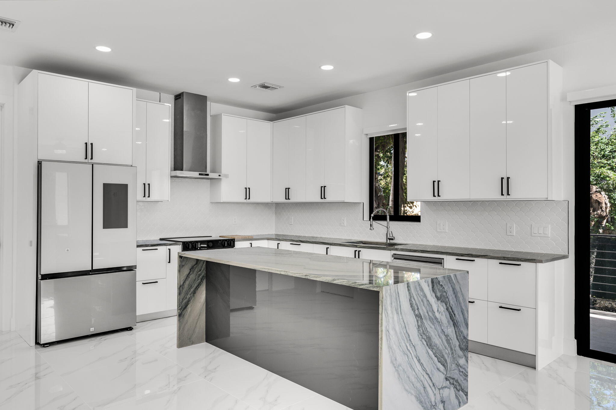 50 Transylvania Avenue Key Largo, FL 33037 - Photo 11 of 59 a kitchen with a sink stainless steel appliances and white cabinets