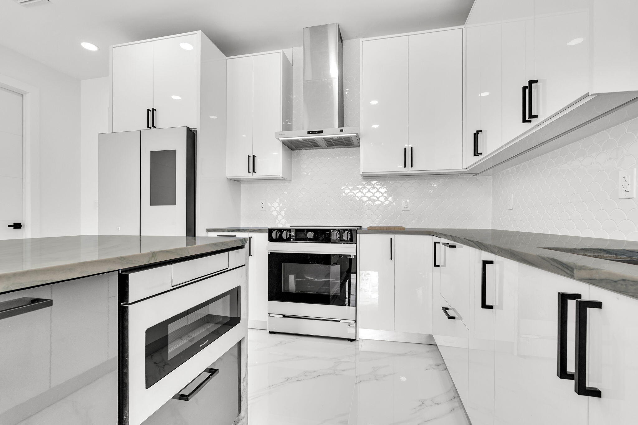 50 Transylvania Avenue Key Largo, FL 33037 - Photo 12 of 59 a kitchen with stainless steel appliances granite countertop a stove and white cabinets