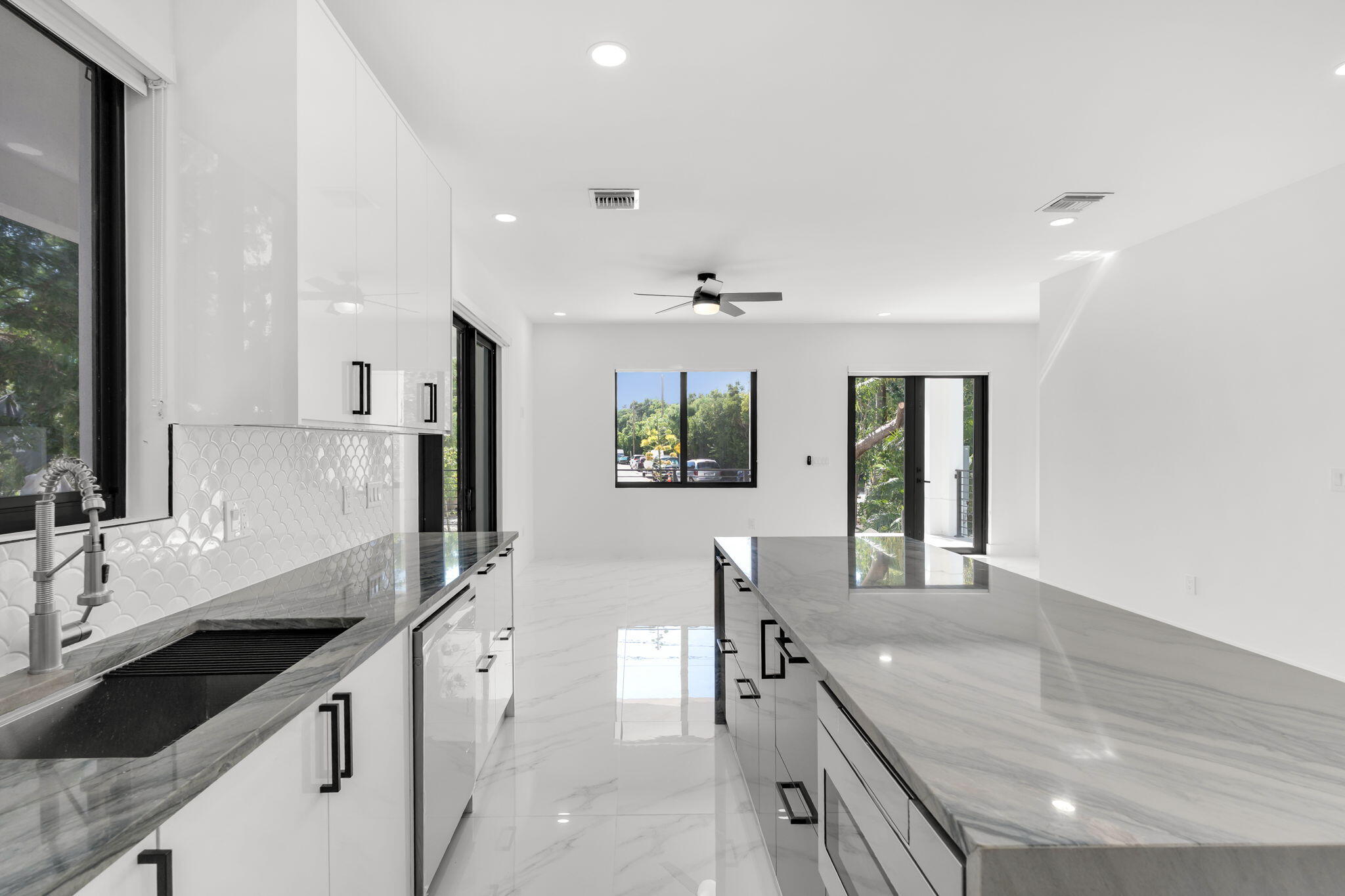 50 Transylvania Avenue Key Largo, FL 33037 - Photo 13 of 59 a large kitchen with kitchen island granite countertop a large window and stainless steel appliances