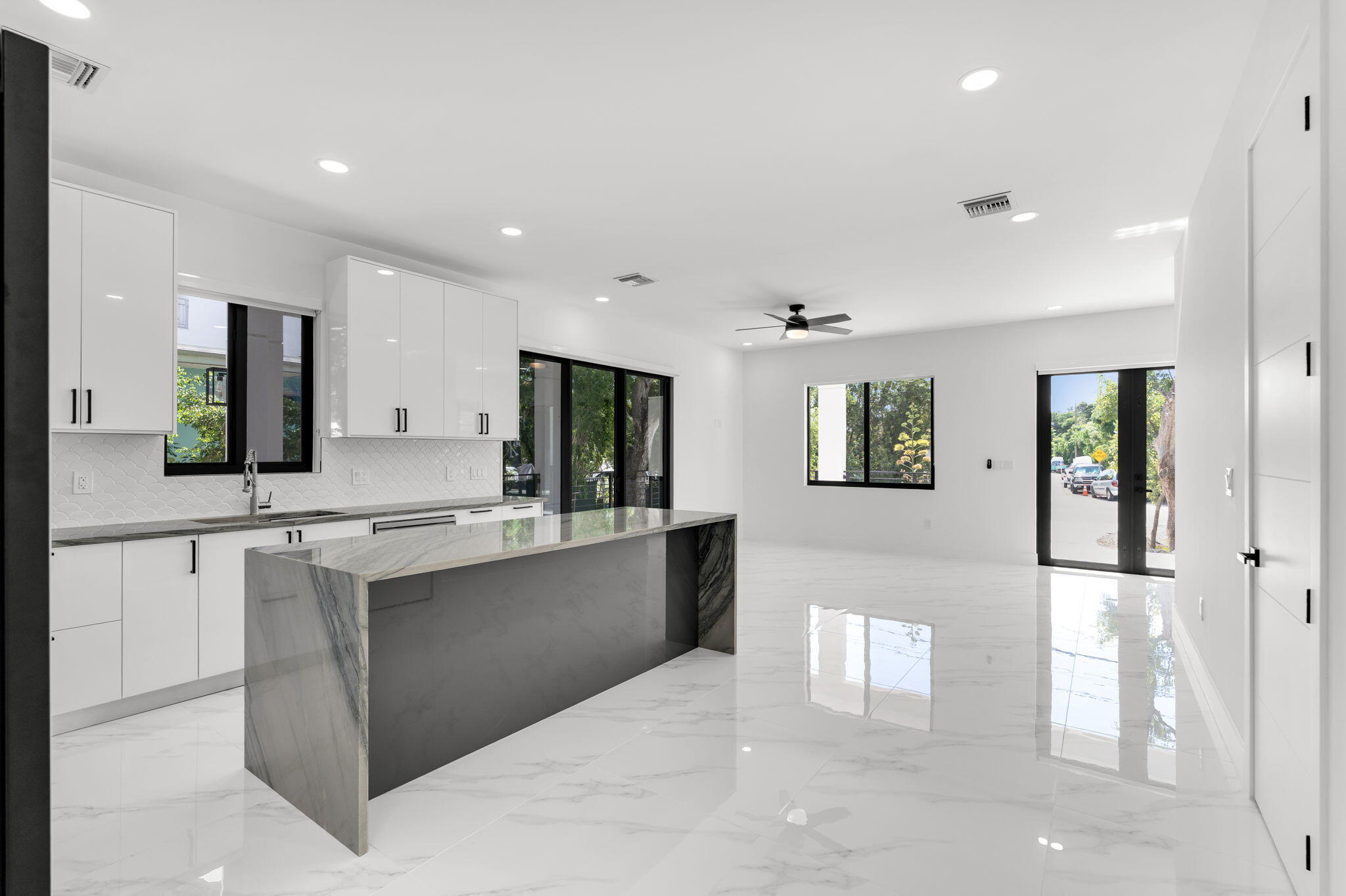50 Transylvania Avenue Key Largo, FL 33037 - Photo 14 of 59 a large white kitchen with cabinets and a couch