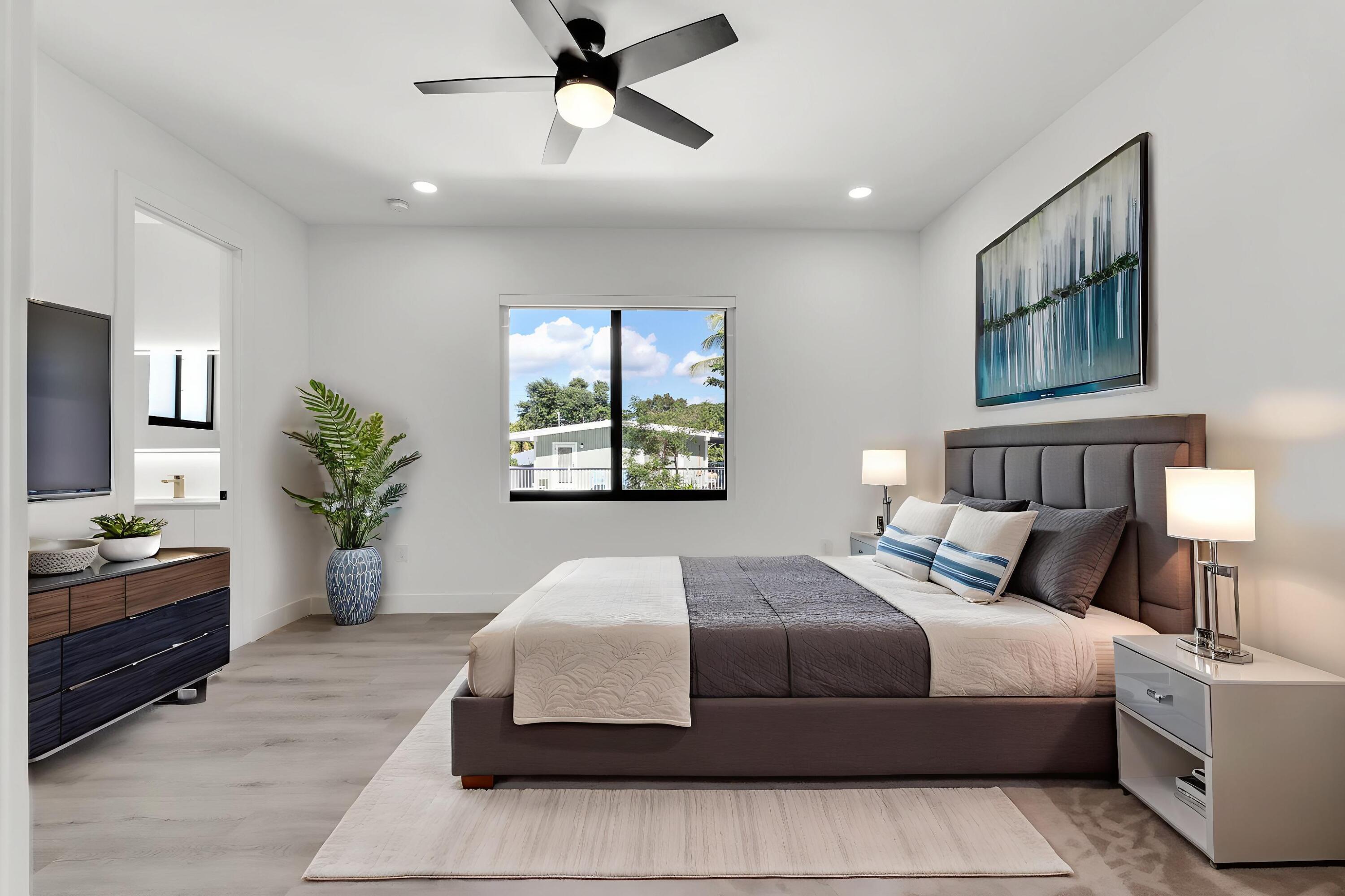 50 Transylvania Avenue Key Largo, FL 33037 - Photo 19 of 59 a bedroom with a large bed and a chandelier