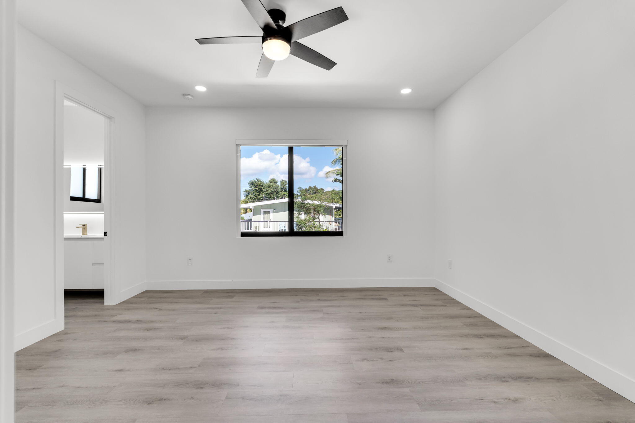 50 Transylvania Avenue Key Largo, FL 33037 - Photo 20 of 59 wooden floor in an empty room with a window