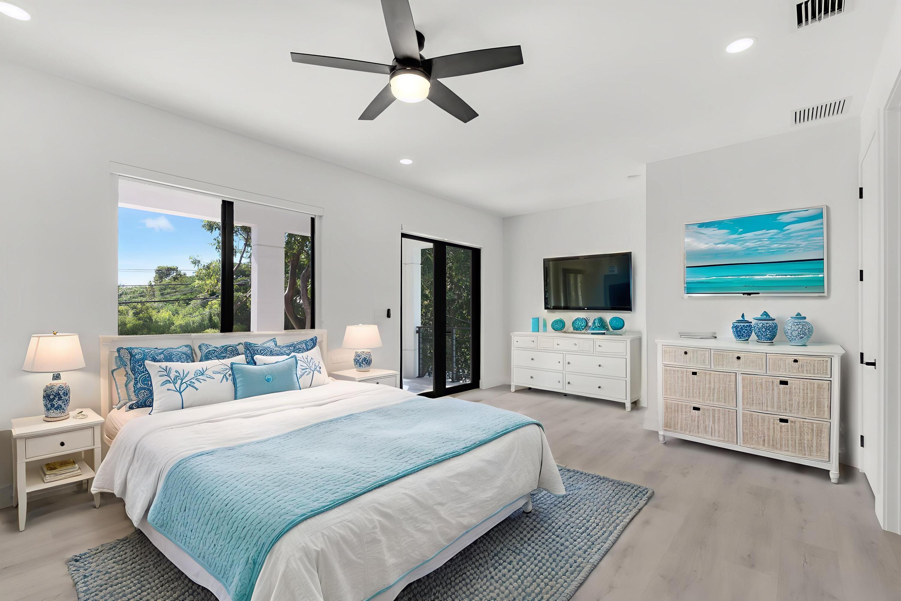 50 Transylvania Avenue Key Largo, FL 33037 - Photo 23 of 59 a bedroom with a large bed and a flat tv screen on dresser