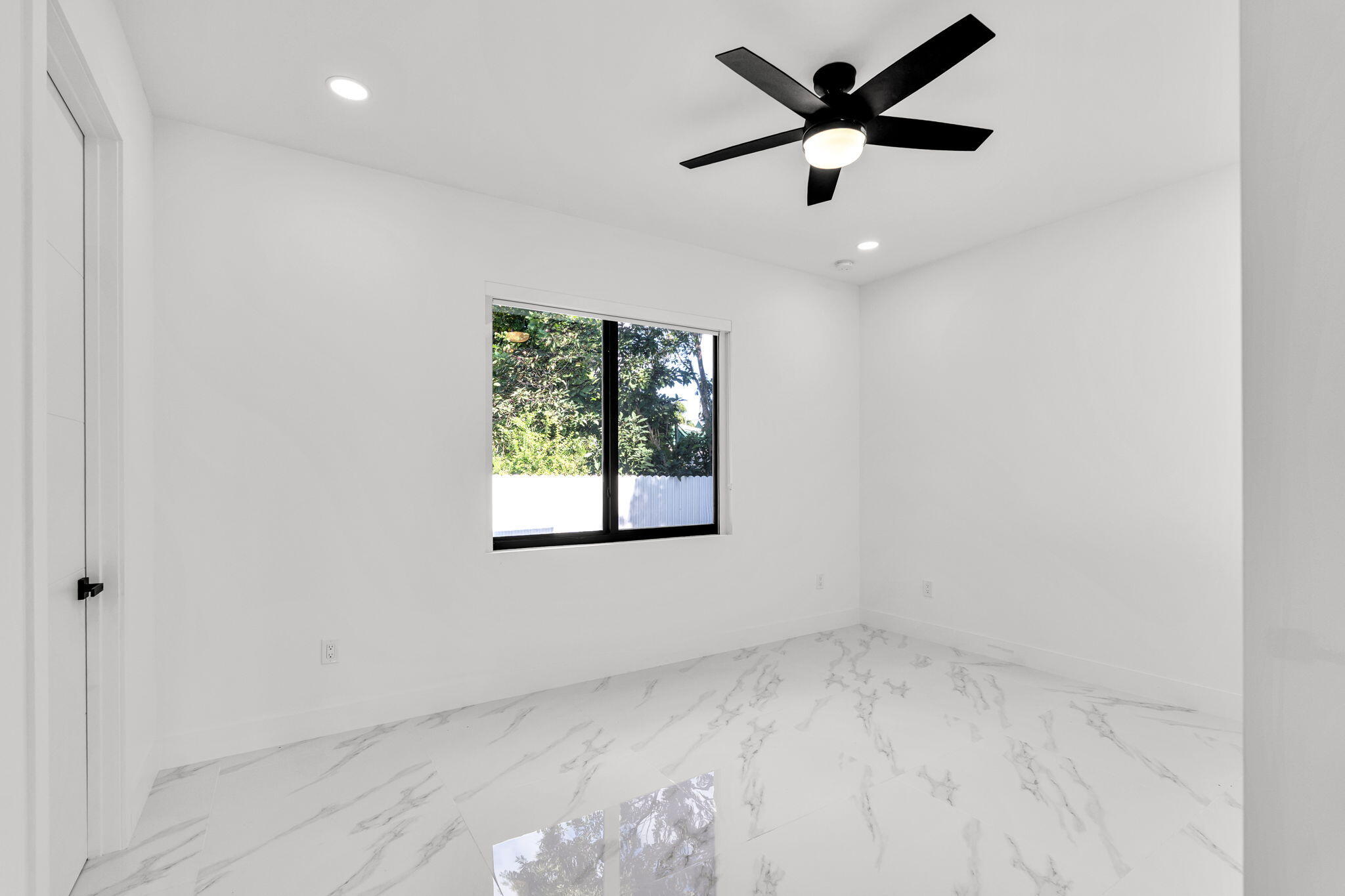 50 Transylvania Avenue Key Largo, FL 33037 - Photo 38 of 59 an empty room with a window and a fan