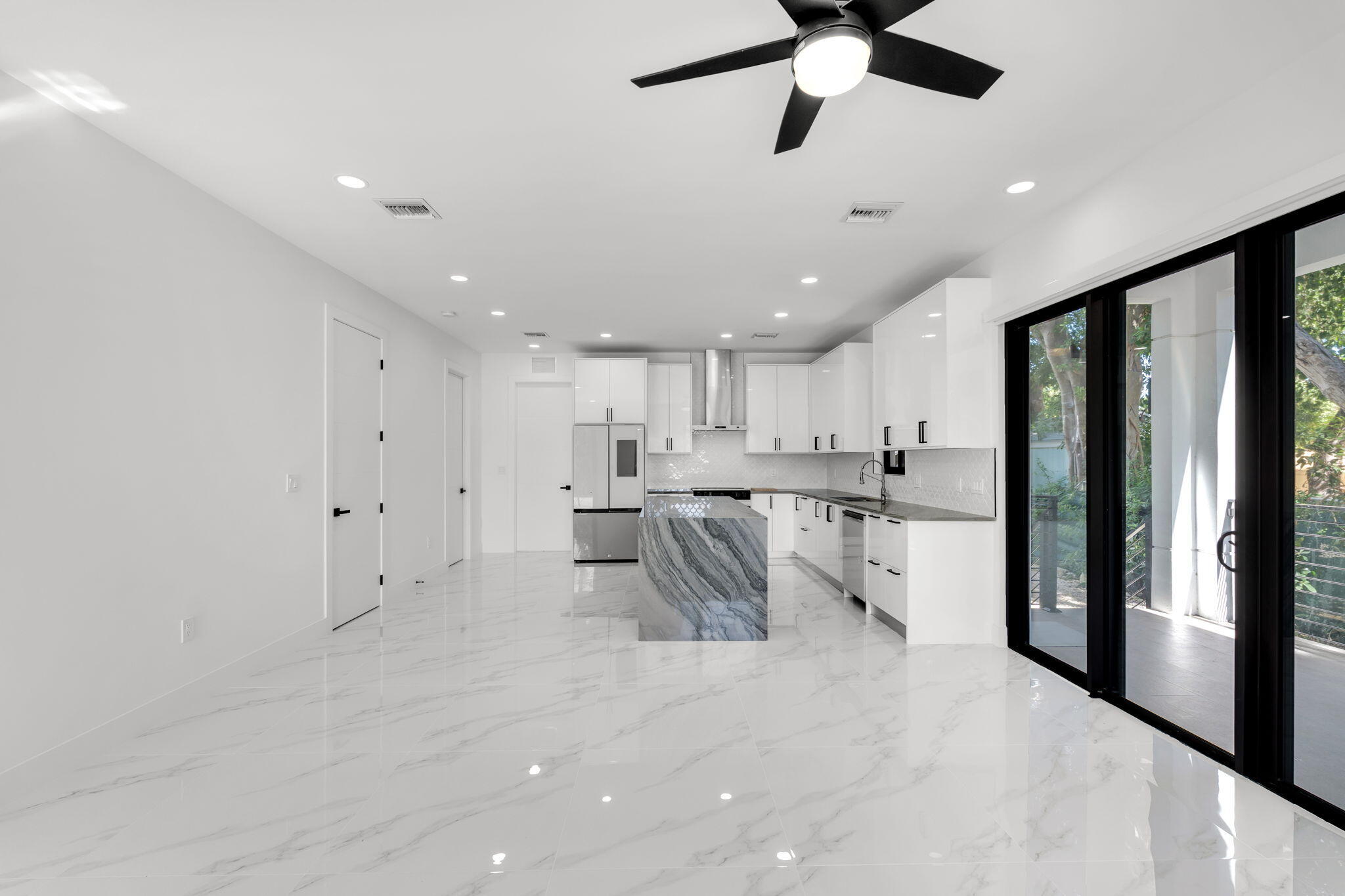 50 Transylvania Avenue Key Largo, FL 33037 - Photo 9 of 59 a kitchen with stainless steel appliances kitchen island granite countertop a refrigerator and a sink