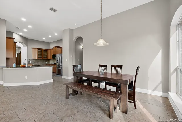 a living room with furniture a dining table and kitchen view