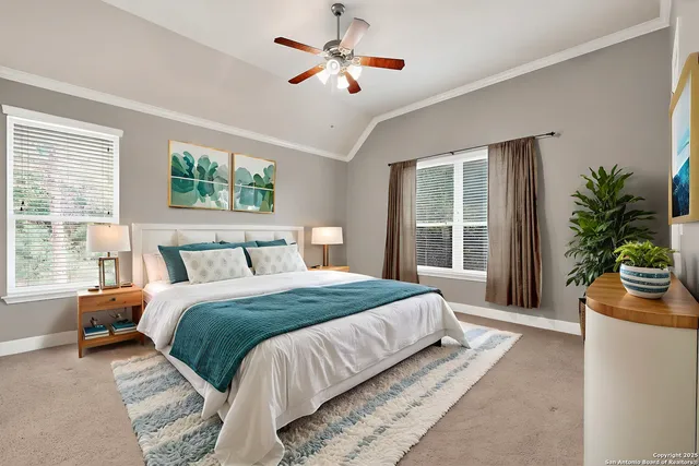 a bedroom with a large bed and a large window