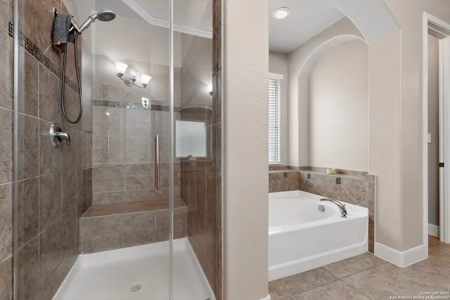a bathroom with a bathtub and a shower