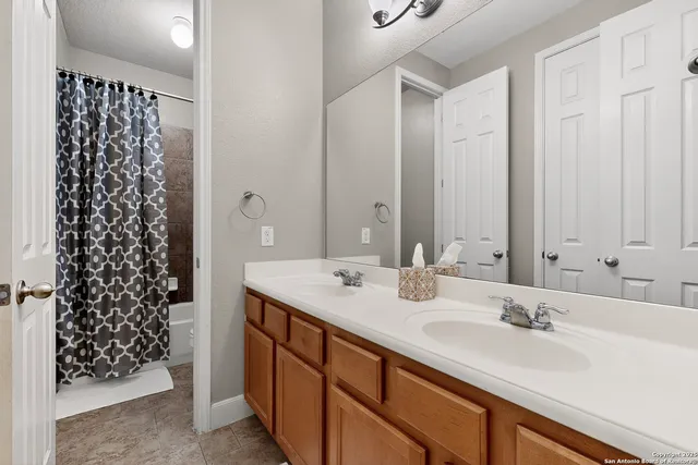 a bathroom with a double vanity sink and a mirror
