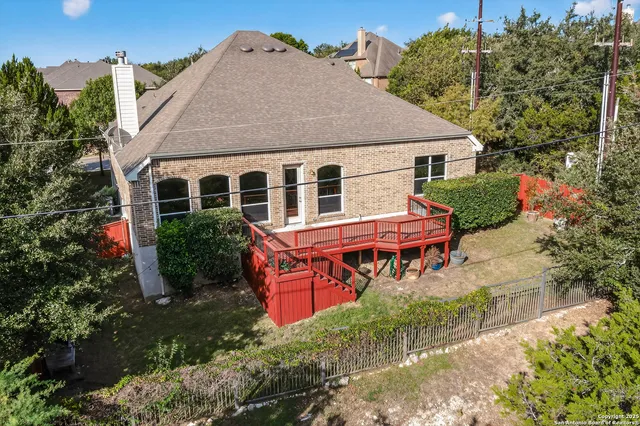 an aerial view of a house with yard and sitting area