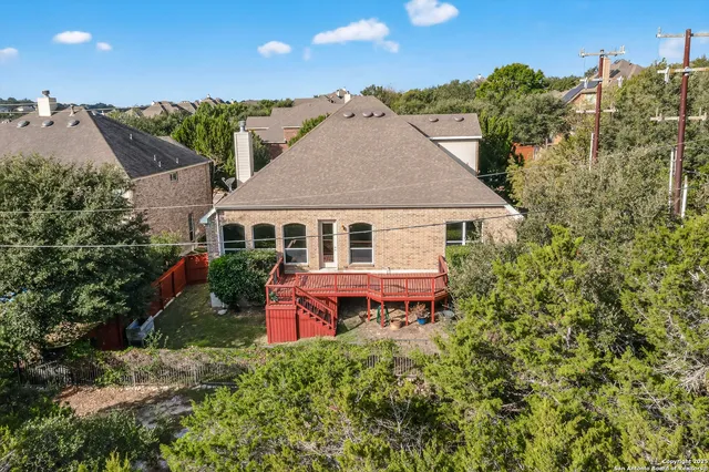 a aerial view of a house with table and chairs under an umbrella