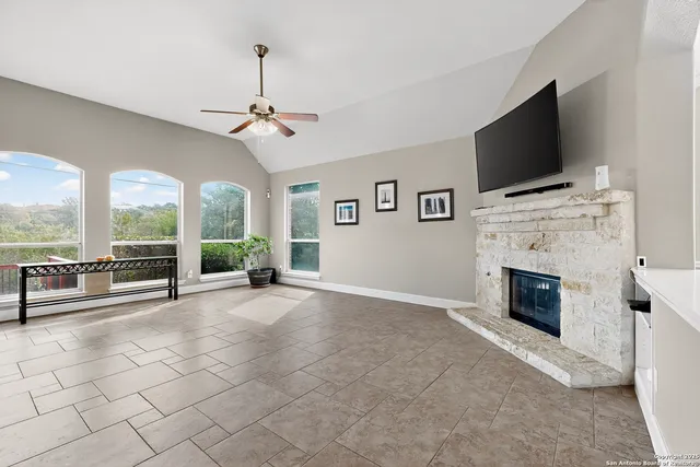 a living room with fireplace furniture and a flat screen tv