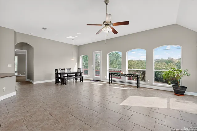 a view of a room with gym equipment and large windows